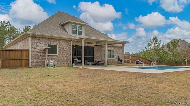 back of property with ceiling fan, a fenced backyard, brick siding, a fenced in pool, and a patio area