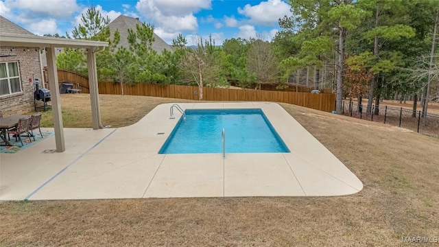 view of swimming pool featuring a patio, a yard, a fenced backyard, and a fenced in pool