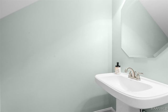 bathroom featuring a sink and baseboards