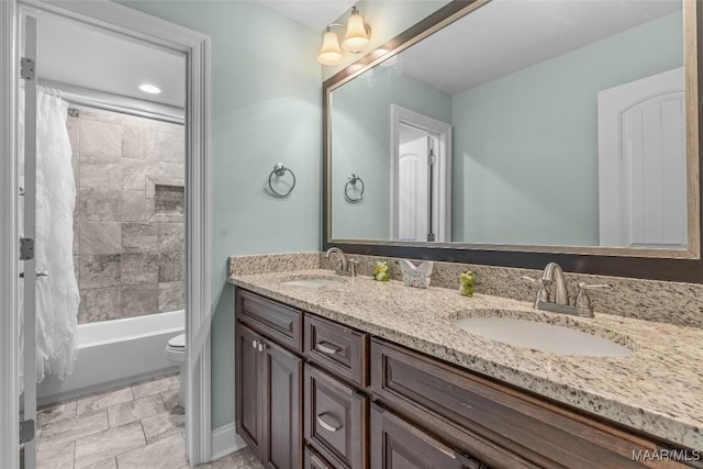 full bath with double vanity, toilet, shower / bath combo with shower curtain, and a sink