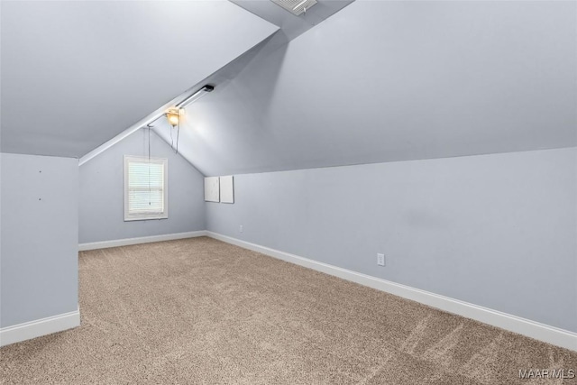 additional living space featuring carpet, visible vents, baseboards, and vaulted ceiling