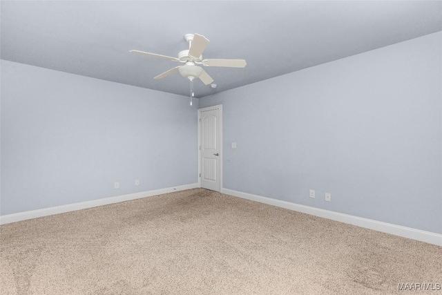 empty room featuring ceiling fan, carpet flooring, and baseboards