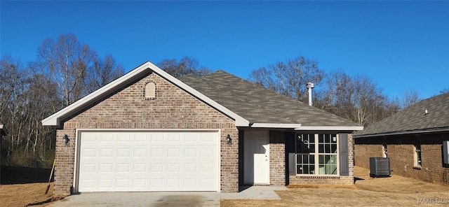 view of front of house featuring driveway, brick siding, roof with shingles, and an attached garage