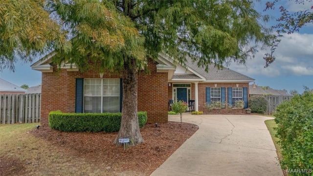 view of front of property featuring brick siding and fence