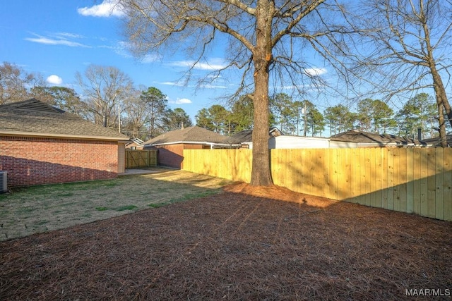 view of yard with cooling unit and a fenced backyard