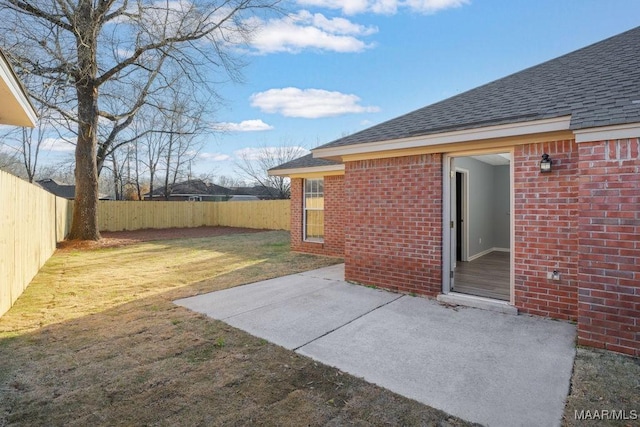 view of yard featuring a patio area and a fenced backyard