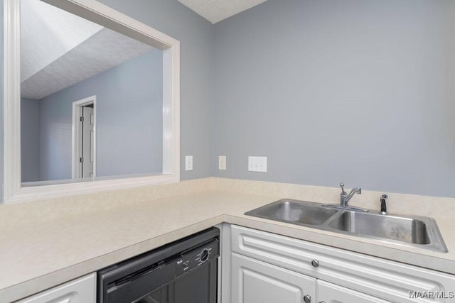 kitchen with a textured ceiling, a sink, white cabinets, black dishwasher, and light countertops