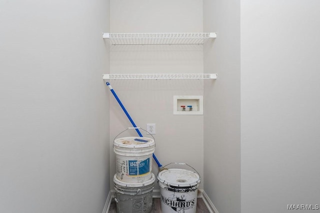 clothes washing area featuring laundry area, washer hookup, and baseboards