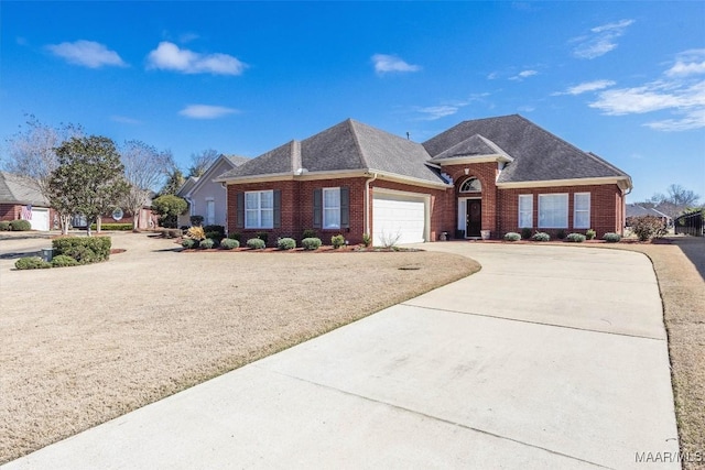 view of front of property featuring a shingled roof, brick siding, driveway, and an attached garage