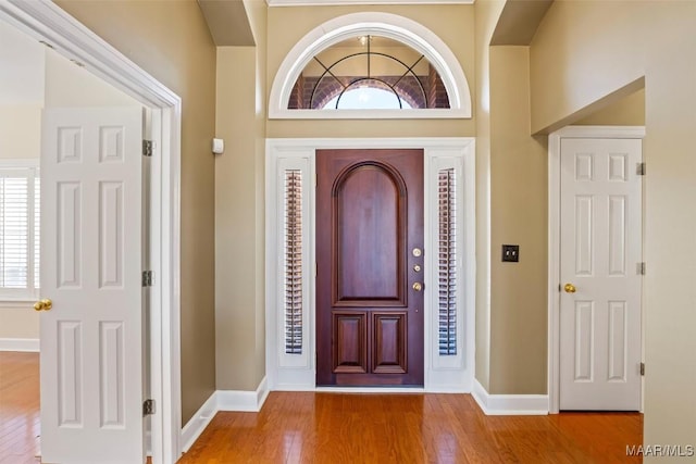 entryway featuring baseboards and hardwood / wood-style floors