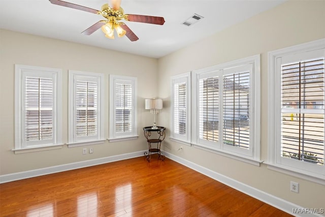 spare room with light wood-style floors, plenty of natural light, visible vents, and baseboards