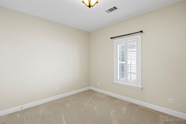 unfurnished room with light carpet, baseboards, and visible vents