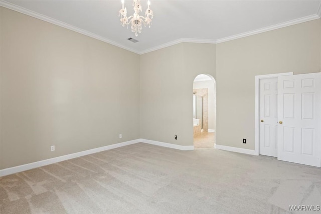 unfurnished room with arched walkways, light colored carpet, crown molding, and baseboards