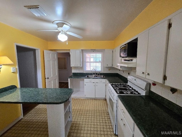 kitchen with white gas range oven, visible vents, white cabinets, under cabinet range hood, and a sink