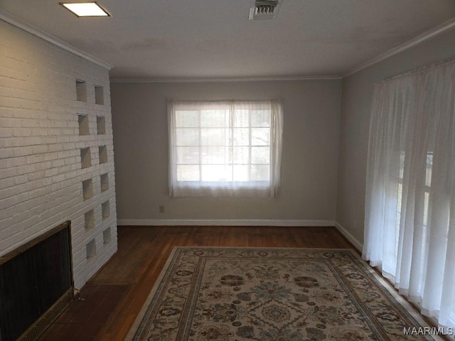 unfurnished living room featuring crown molding, visible vents, dark wood finished floors, and baseboards