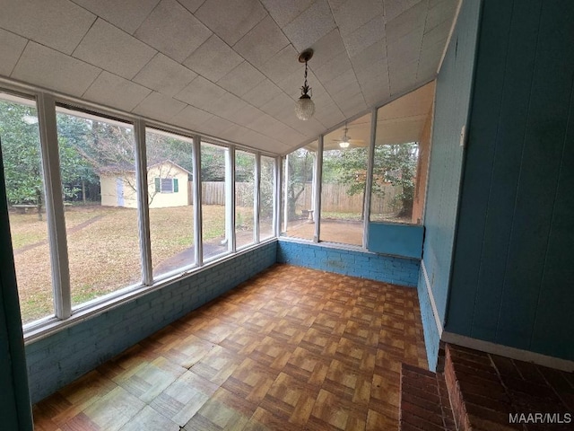 unfurnished sunroom featuring lofted ceiling