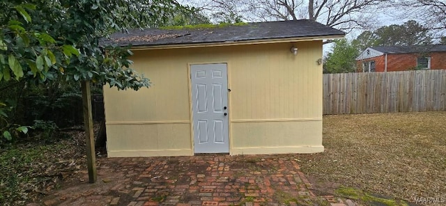 view of outdoor structure featuring an outbuilding and fence