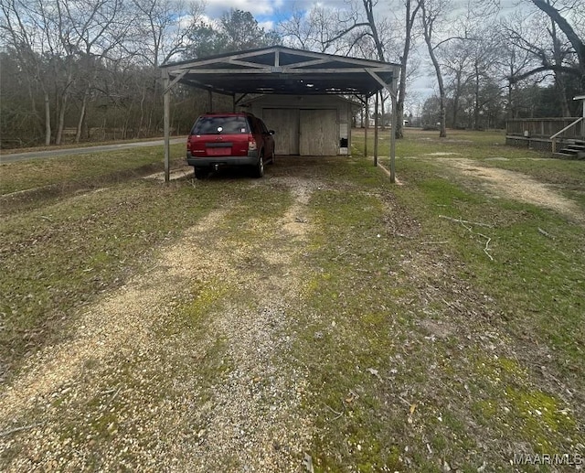 view of parking with dirt driveway and a carport