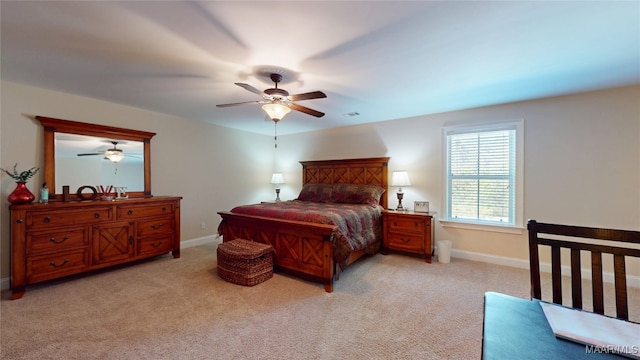 bedroom featuring a ceiling fan, light colored carpet, and baseboards