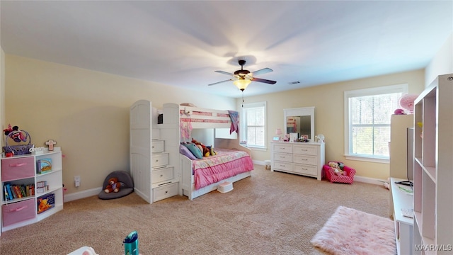 bedroom featuring light carpet, ceiling fan, visible vents, and baseboards