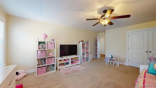 game room with light carpet, baseboards, and a ceiling fan