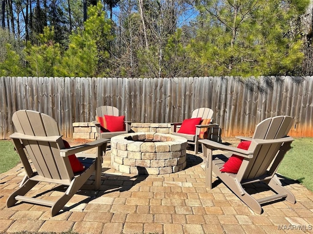 view of patio / terrace with an outdoor fire pit and a fenced backyard