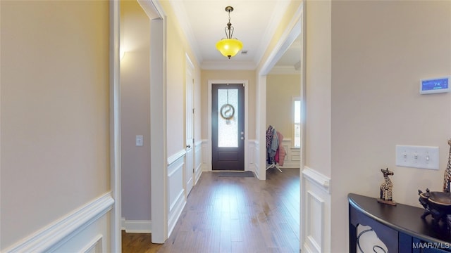 entrance foyer with a decorative wall, dark wood finished floors, and crown molding