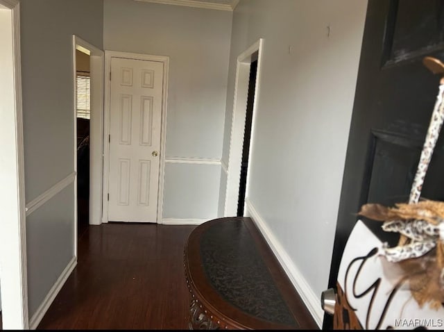 hall featuring baseboards and wood finished floors