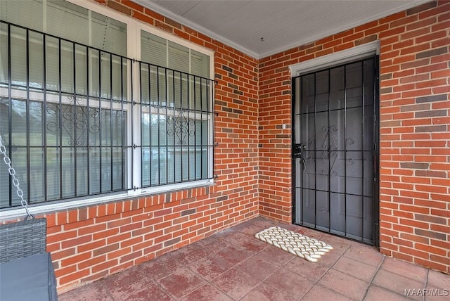 property entrance with brick siding