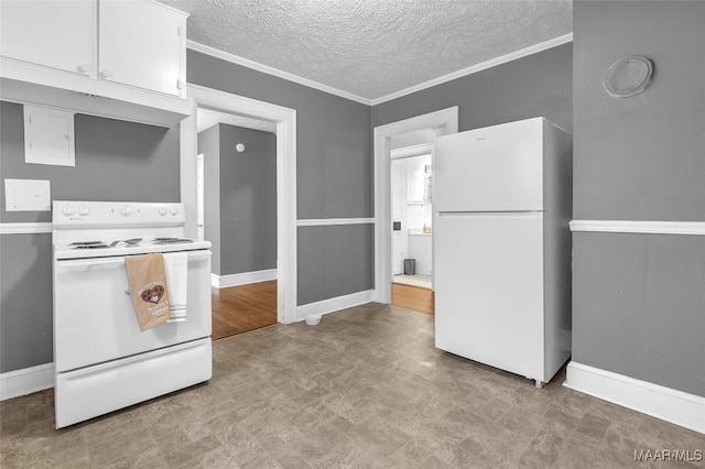 kitchen with white appliances, white cabinets, light countertops, ornamental molding, and light floors