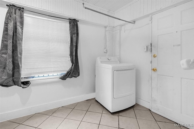 laundry area with laundry area, baseboards, washer / clothes dryer, and light tile patterned flooring