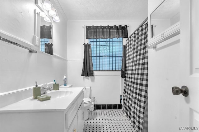 full bath featuring toilet, crown molding, a textured ceiling, and vanity