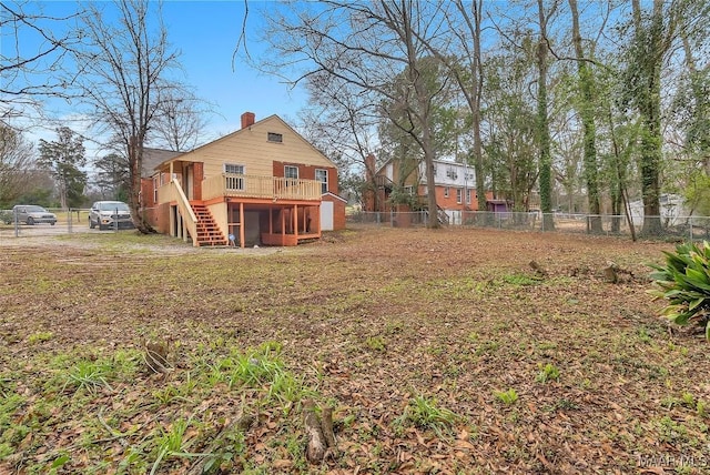 view of yard featuring stairs, fence, and a wooden deck