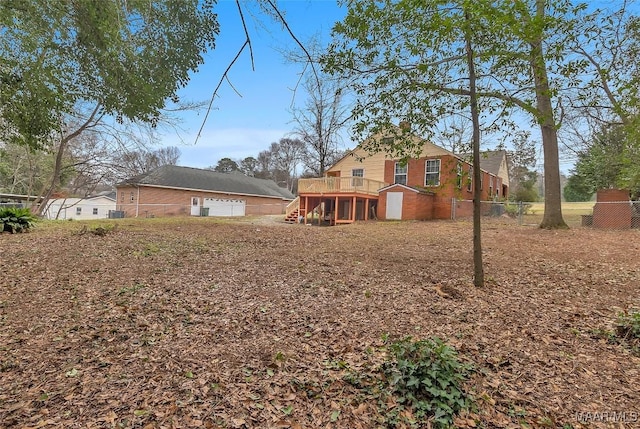 exterior space with stairs, fence, and a deck