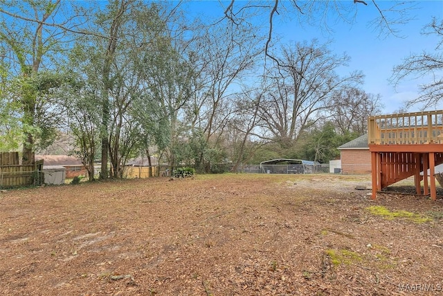 view of yard with a deck and fence