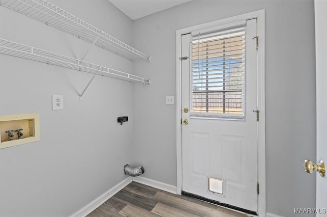 laundry room with laundry area, baseboards, wood finished floors, hookup for a washing machine, and hookup for an electric dryer