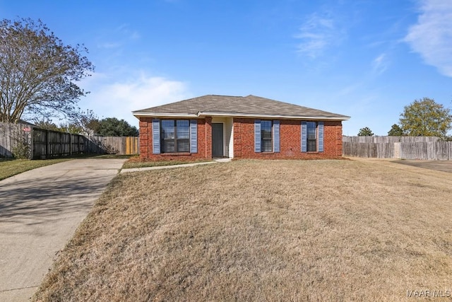 single story home with a front lawn, fence, and brick siding