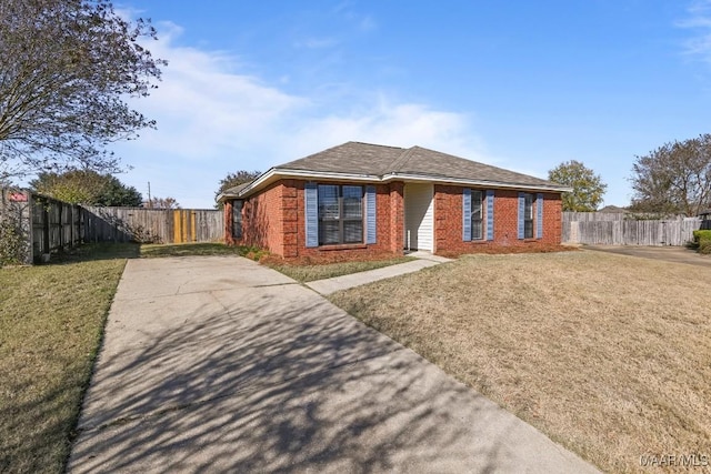 ranch-style house featuring brick siding, fence, and a front yard