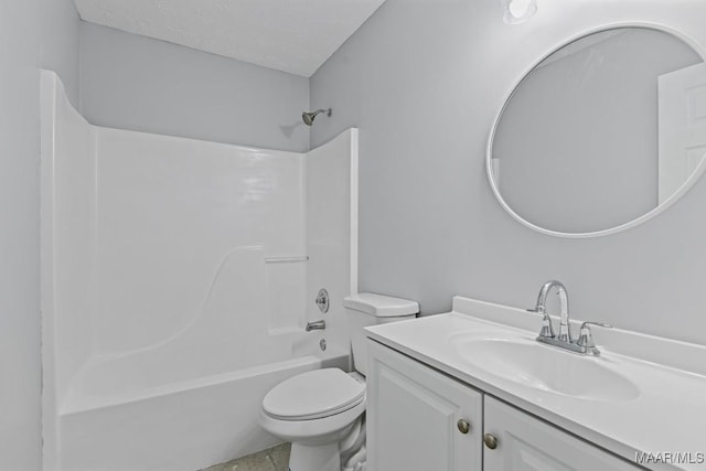 bathroom featuring a textured ceiling, bathtub / shower combination, vanity, and toilet