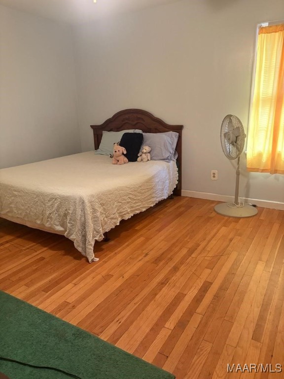 bedroom with light wood-style floors and baseboards