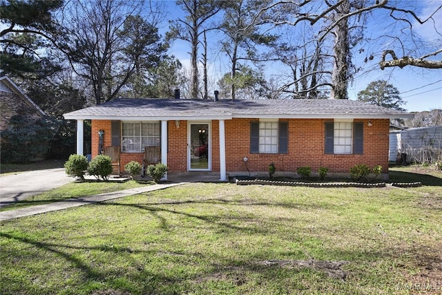 ranch-style home with brick siding and a front yard