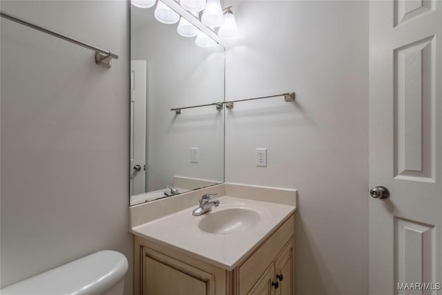 half bath featuring toilet and vanity