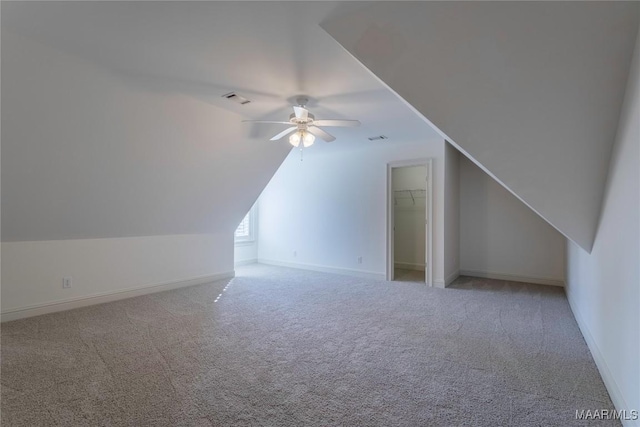 additional living space featuring carpet floors, lofted ceiling, visible vents, ceiling fan, and baseboards