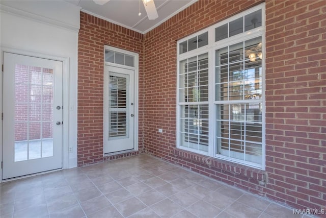 exterior space featuring a ceiling fan and brick siding