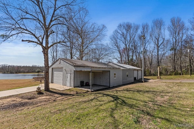 exterior space featuring concrete driveway and a water view