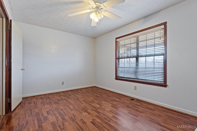 unfurnished room featuring ceiling fan, a textured ceiling, visible vents, and wood finished floors