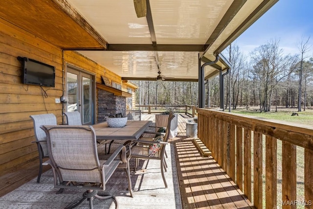 deck featuring ceiling fan and outdoor dining area