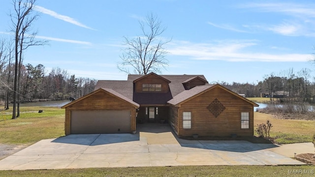 view of front facade featuring driveway, an attached garage, a water view, and a front yard