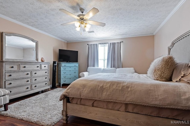 bedroom with a textured ceiling, dark wood-type flooring, visible vents, and crown molding