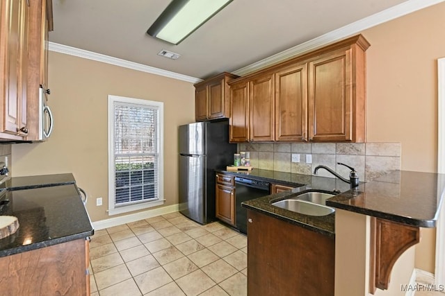 kitchen with black appliances, ornamental molding, brown cabinetry, and a sink